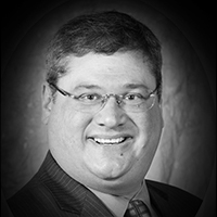 A headshot of David Caplan
