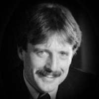A headshot of David Ramsay