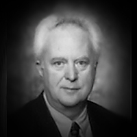 A headshot of Derwyn Shea
