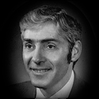 A headshot of John Roland Sweeney