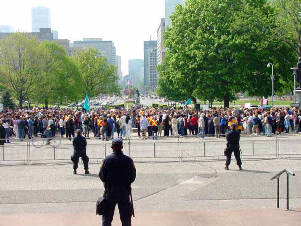 demonstration on the front lawn of the Legislature with three officers facing the crowd