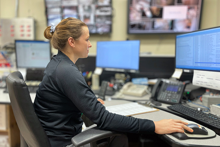 communications operator seated at desk in front of computer