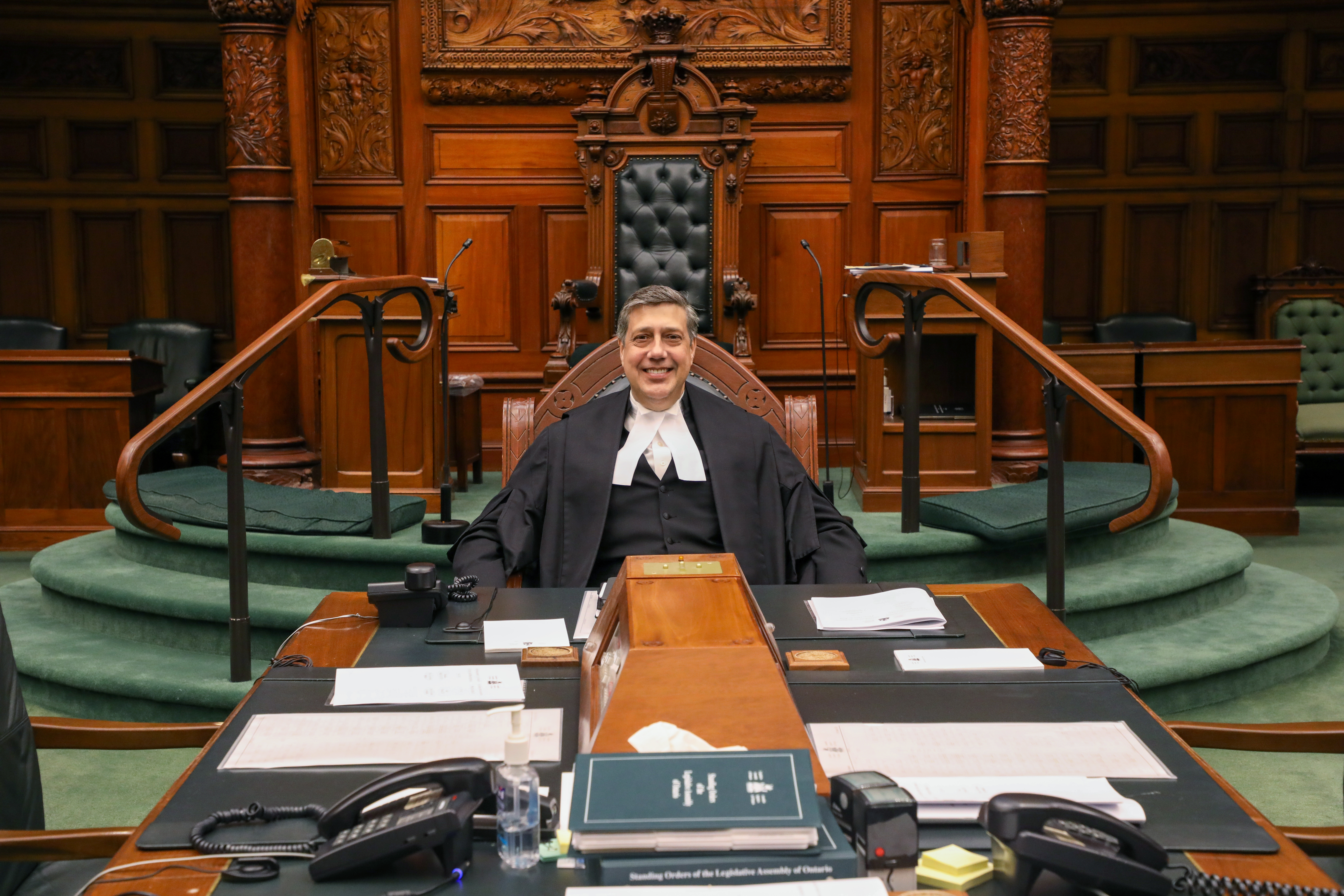 Clerk Day sitting at the table in the Chamber