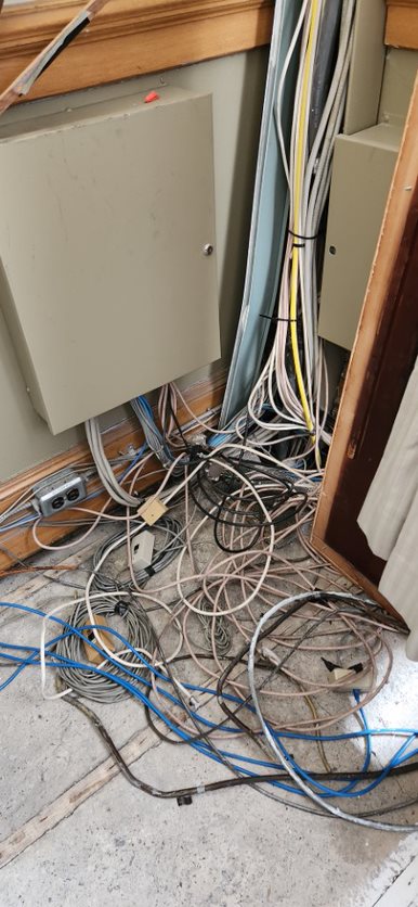 Picture showing vertical cable congestion against along a wall.